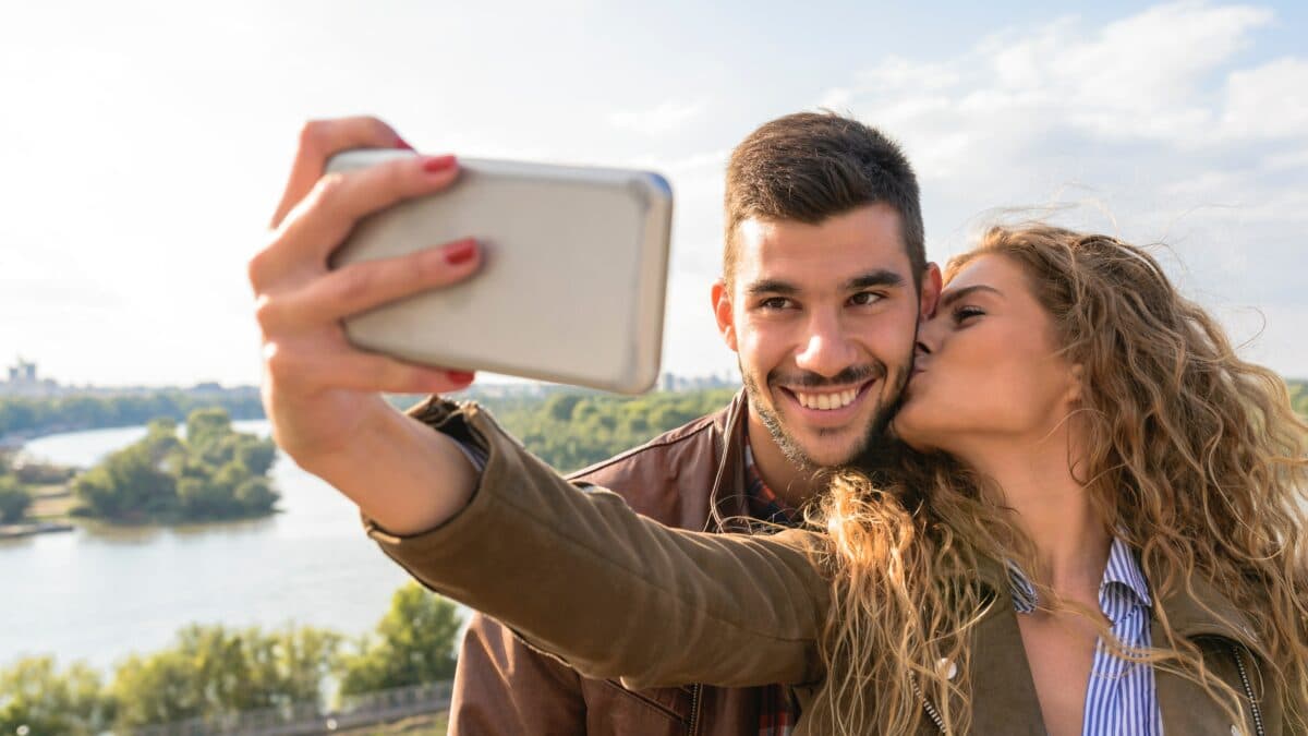 A couple taking a selfie outdoors