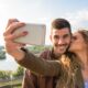 A couple taking a selfie outdoors