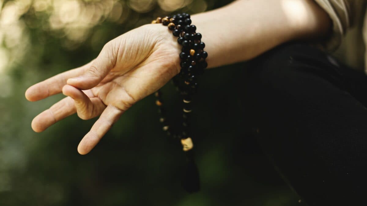 A hand positioned in a meditation gesture