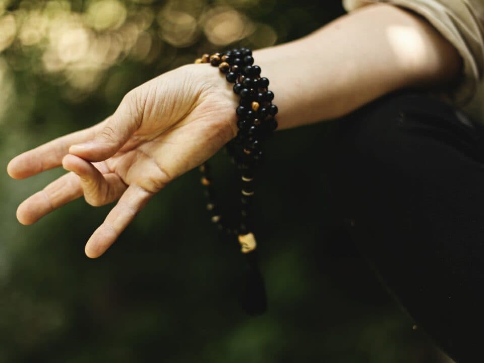 A hand positioned in a meditation gesture