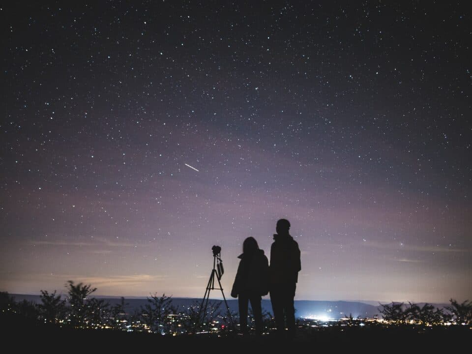 Silhouette of two couple stargazing