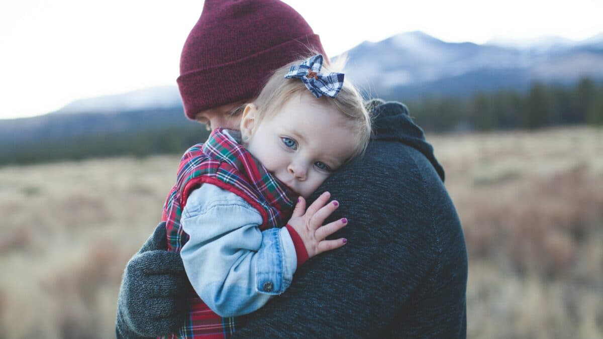 a mother carrying her child