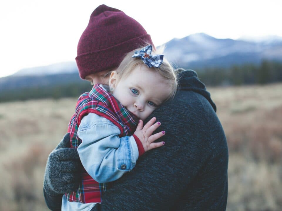 a mother carrying her child