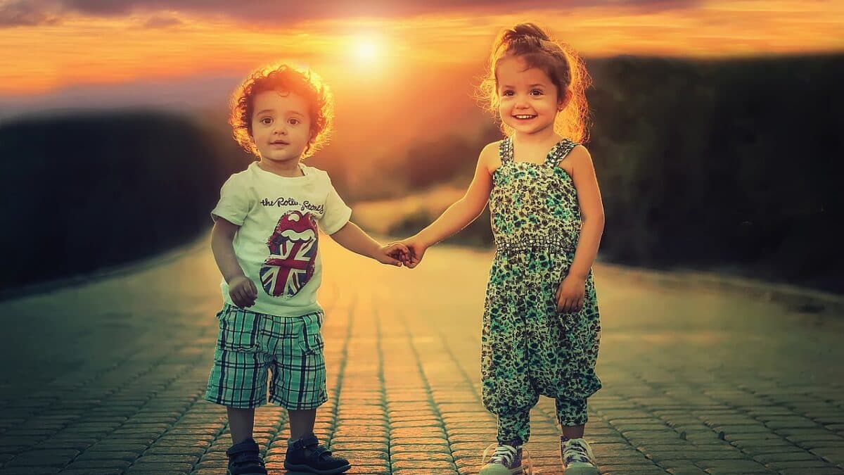 two adorable children holding hands