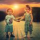 two adorable children holding hands