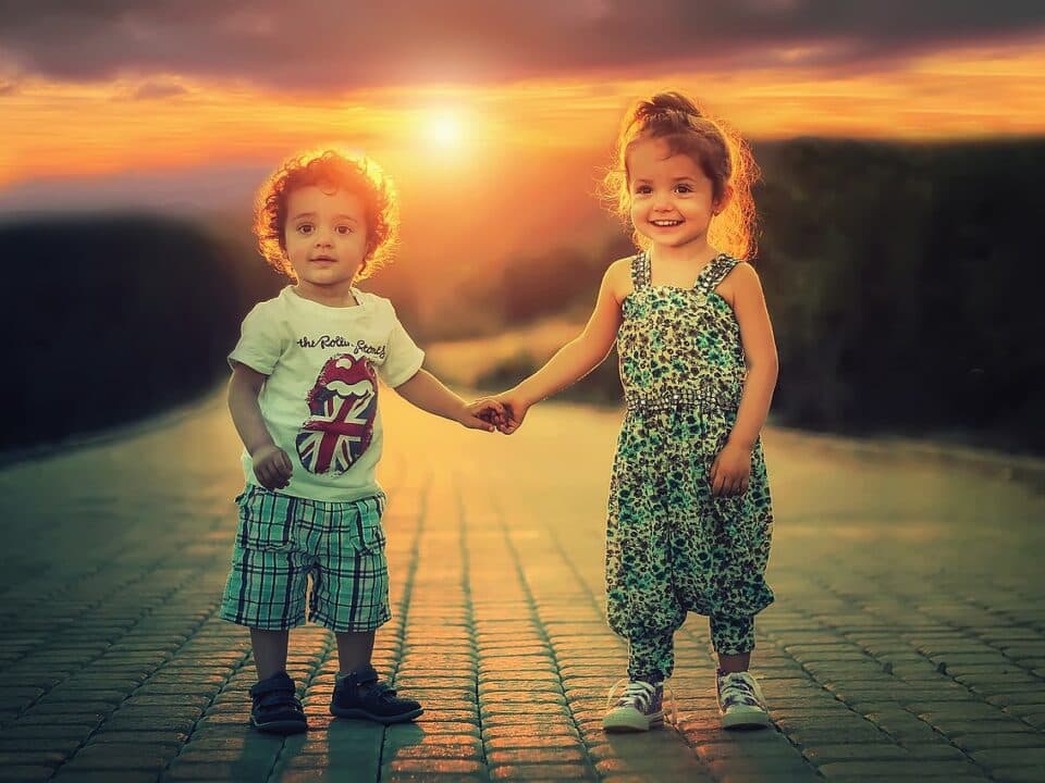 two adorable children holding hands