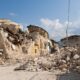 a destroyed small building after an earthquake