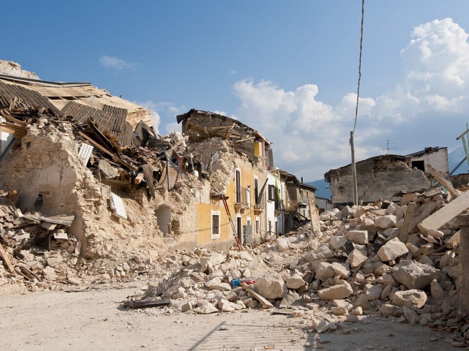 a destroyed small building after an earthquake