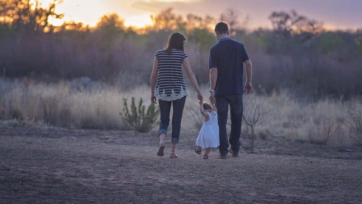 a family walking through the bushes
