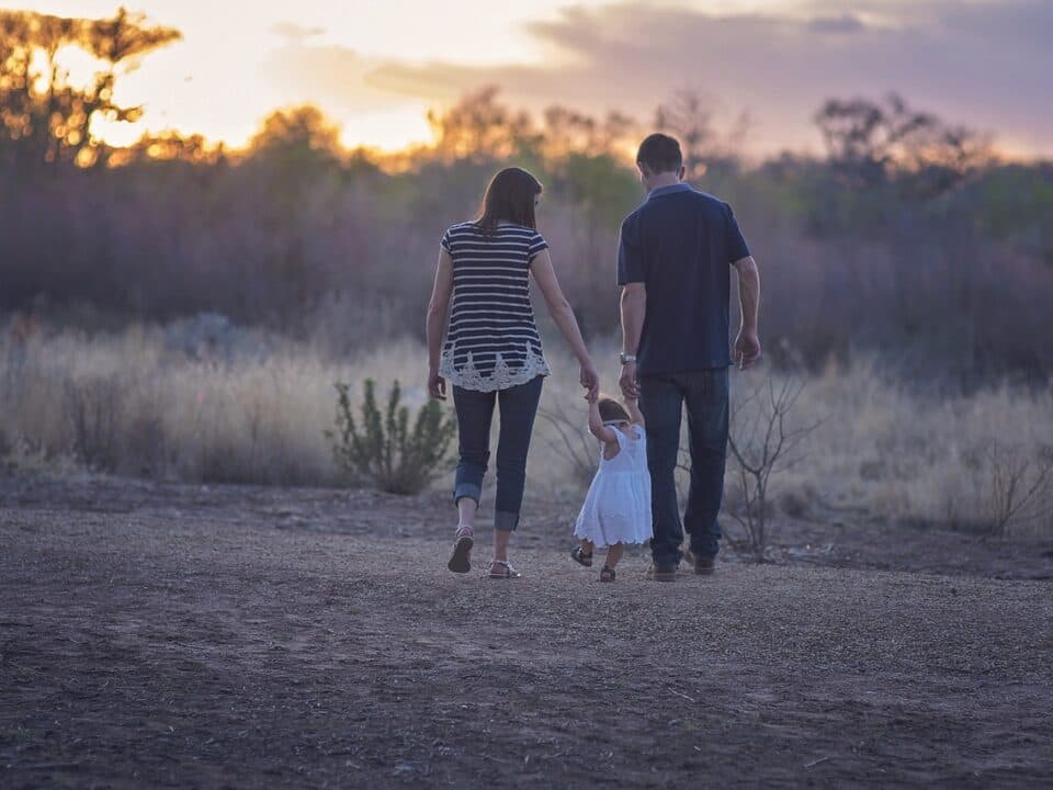 a family walking through the bushes