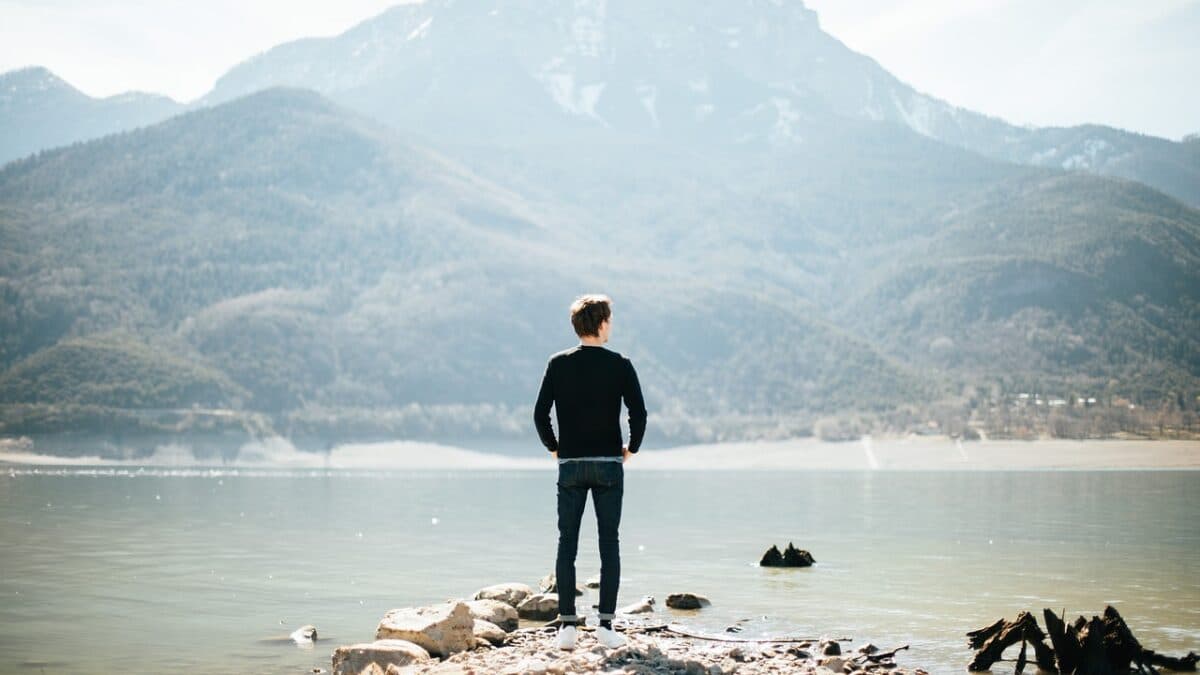 man looking into the distance at a mountain