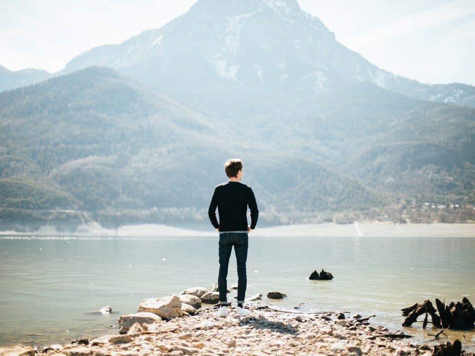 man looking into the distance at a mountain