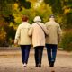 three elderly people walking together