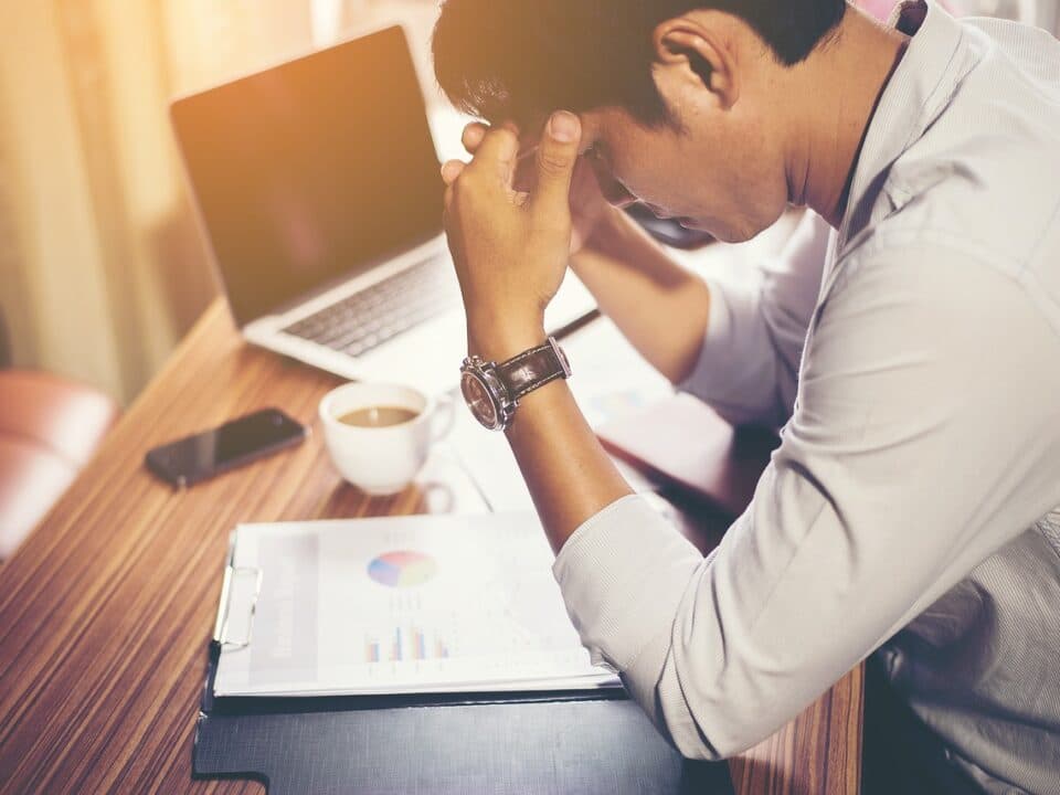 a stressed man looking at his work