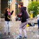 girl and boy kids playing together with bubbles in the street
