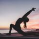 a woman doing yoga on concrete beach