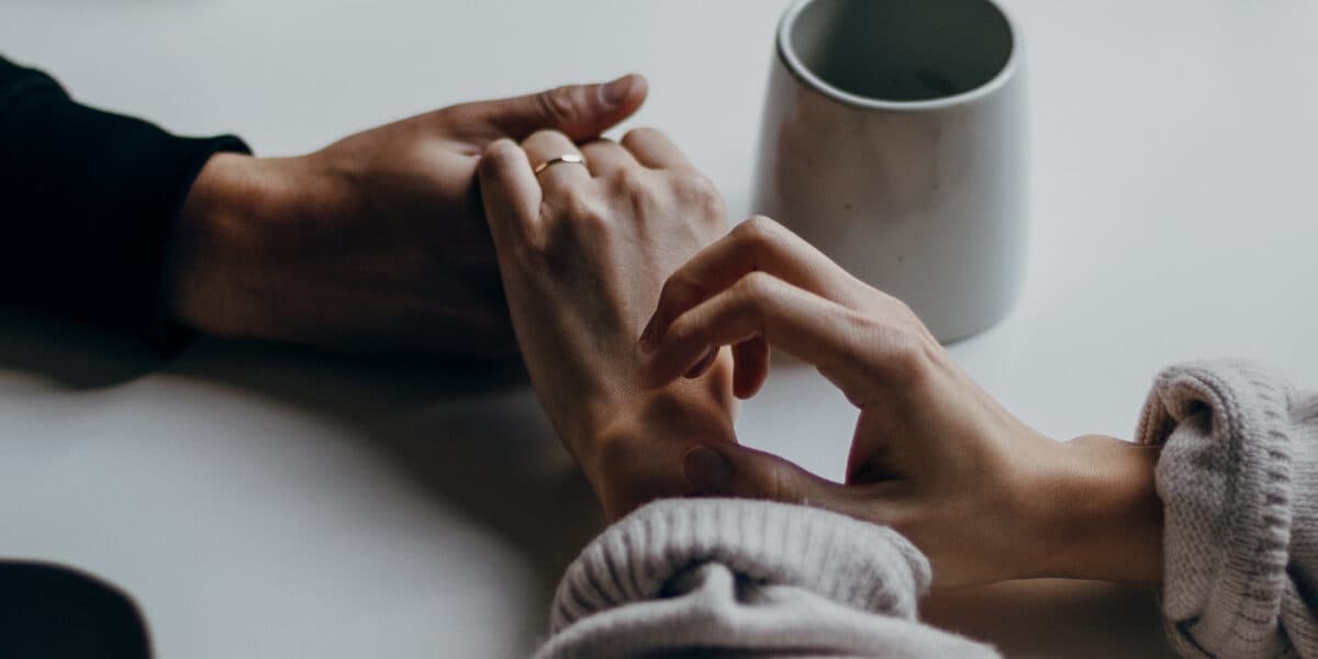 holding hands to support