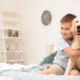 cute boy hugging an adorable dog in bed