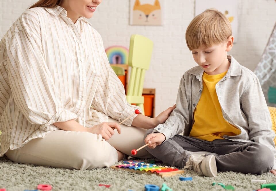 A woman and a young boy playing