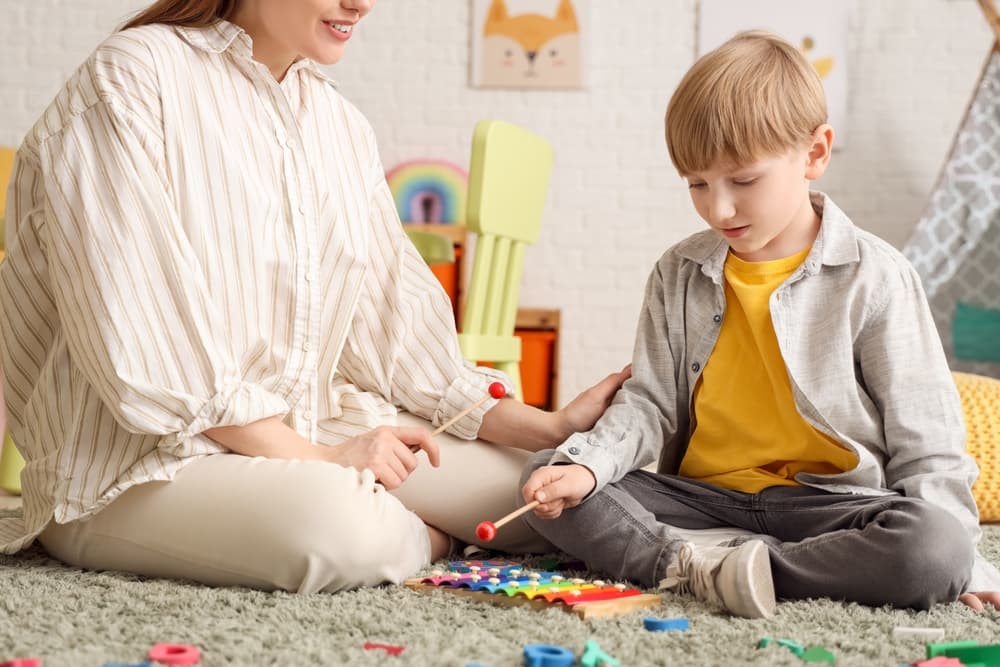 A woman and a young boy playing
