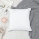 image of pillow on top of blanket with cup of coffee on the side
